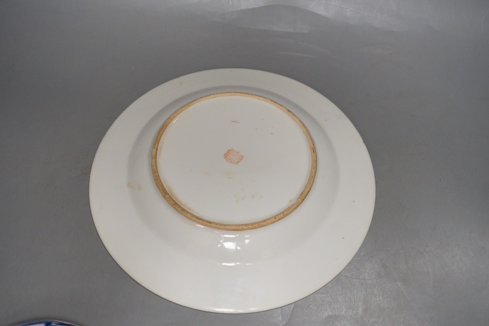 Three Japanese Arita dishes and a Chinese dragon plate, largest 23cm diameter